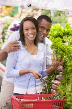 Royalty Free Photo of a Young Couple Shopping for Vegetables