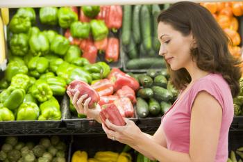 Royalty Free Photo of a Woman Shopping for Peppers