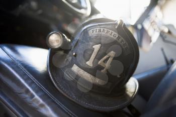 Royalty Free Photo of a Firefighter's Helmet on the Seat of the Firetruck