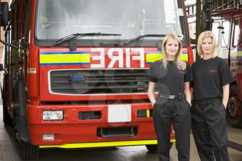 Royalty Free Photo of Two Female Firefighters in Front of the Truck