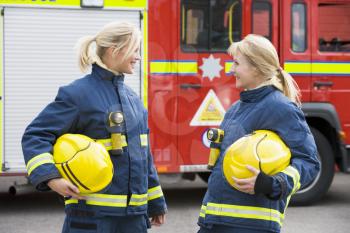 Royalty Free Photo of Two Female Firefighters Talking