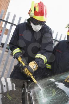 Royalty Free Photo of Firefighters Cutting a Windshield