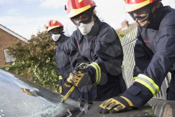 Royalty Free Photo of Firefighters Cutting a Windshield
