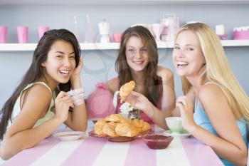 Royalty Free Photo of Three Women Having Tea and Croissants