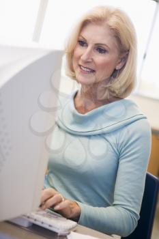 Royalty Free Photo of a Woman Sitting at a Computer