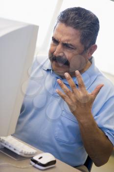 Royalty Free Photo of a Frustrated Man at a Computer