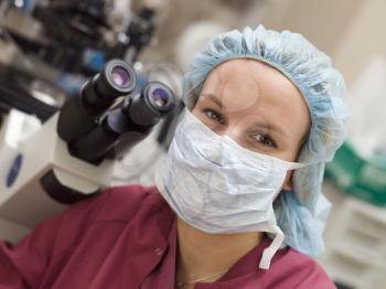 Royalty Free Photo of a Woman Beside a Microscope