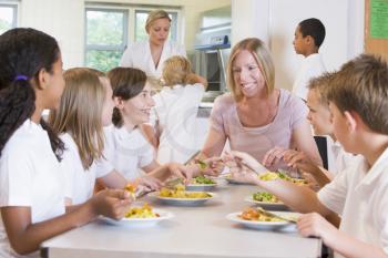 Royalty Free Photo of a Teacher at a Table With Her Students