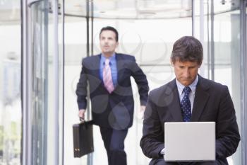 Royalty Free Photo of Two Men in an Office Lobby