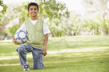 Royalty Free Photo of a Boy With a Soccer Ball in the Park