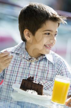 Royalty Free Photo of a Boy Eating Cake