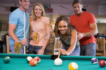 Royalty Free Photo of Friends Playing Pool