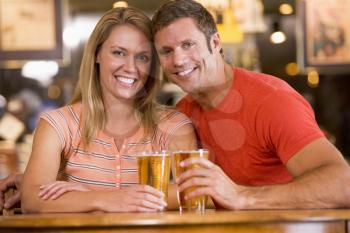 Royalty Free Photo of a Couple Having a Beer Togetehr