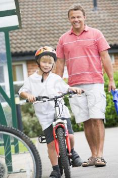 Royalty Free Photo of a Father and Son on a Bike