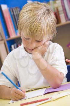 Royalty Free Photo of a Boy Working in School
