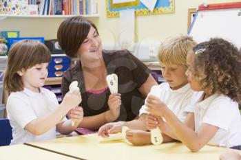 Royalty Free Photo of Teacher and Her Students Learning Numbers