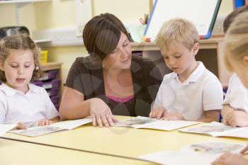 Royalty Free Photo of a Teacher and Students Reading