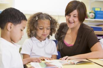 Royalty Free Photo of a Teacher and Students Reading
