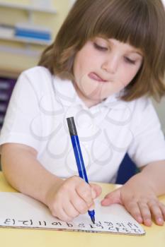 Royalty Free Photo of a Little Girl Writing