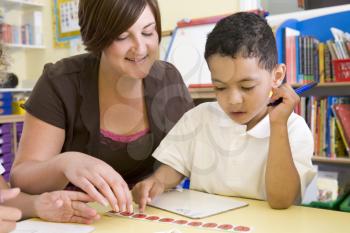 Royalty Free Photo of a Teacher and Boy Counting