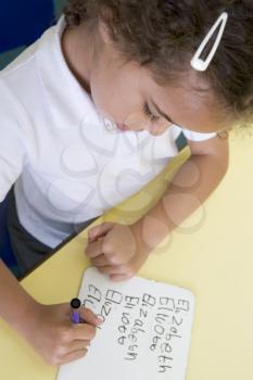 Royalty Free Photo of a Student Writing Her Name
