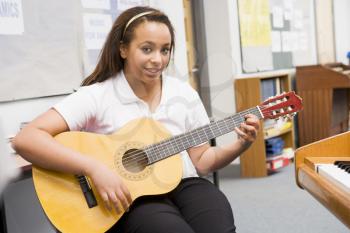 Royalty Free Photo of a Student and a Guitar
