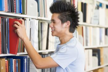 Royalty Free Photo of a Young Guy in a Library