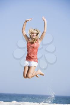 Royalty Free Photo of a Woman Jumping on the Beach