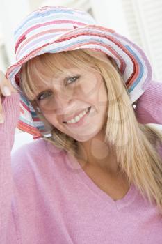 Royalty Free Photo of a Woman in Pink and a Striped Hat