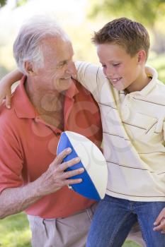 Royalty Free Photo of a Grandson and Grandfather With a Football