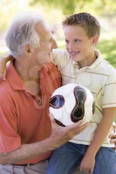 Royalty Free Photo of a Grandfather and Boy With a Soccer Ball