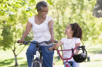 Royalty Free Photo of a Woman and Little Girl Biking