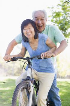Royalty Free Photo of a Couple Riding a Bike