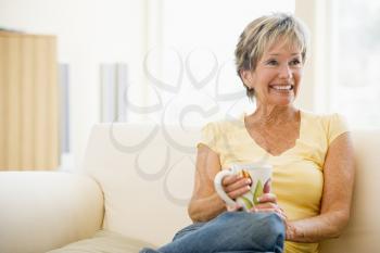 Royalty Free Photo of a Woman In a Living Room With a Coffee