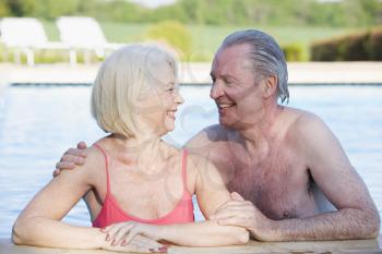 Royalty Free Photo of a Couple at a Swimming Pool