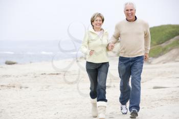 Royalty Free Photo of a Couple Running on the Beach
