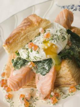 Royalty Free Photo of Seared Salmon Spinach and a Poached Egg in a Vol au Vent Case With a Dill and Keta Caviar Sauce