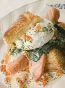 Royalty Free Photo of Seared Salmon Spinach and a Poached Egg in a Vol-au-Vent Case with a Dill and Keta Caviar Sauce