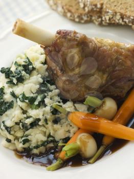 Royalty Free Photo of Slow Roasted Spring Lamb Shank With Colcannon and Soda Bread
