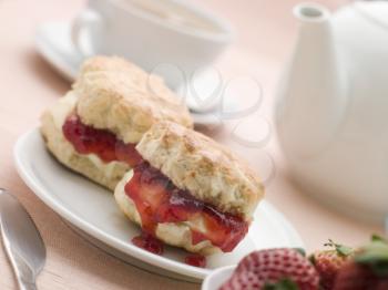 Royalty Free Photo of Scones Jam Clotted Cream and Strawberries with Afternoon Tea