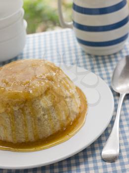 Royalty Free Photo of Steamed Syrup Sponge with a Jug of Custard