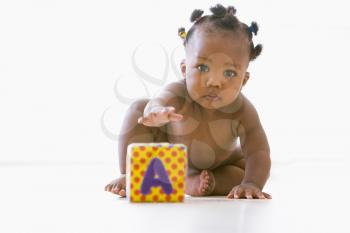 Royalty Free Photo of a Baby Playing With a Block
