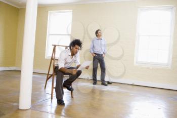 Royalty Free Photo of Two Men in an Empty Room