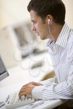 Royalty Free Photo of a Man Listening to Music at a Computer