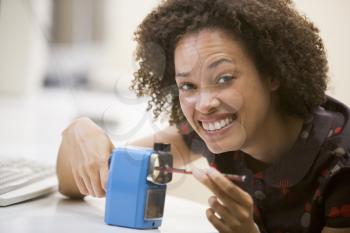Royalty Free Photo of a Woman Using a Pencil Sharpener