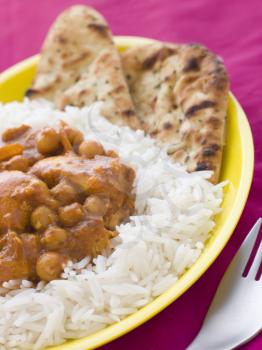 Royalty Free Photo of Chicken and Chickpea Curry With Rice and Naan Bread