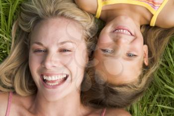 Royalty Free Photo of a Woman and Young Girl Lying in the Grass