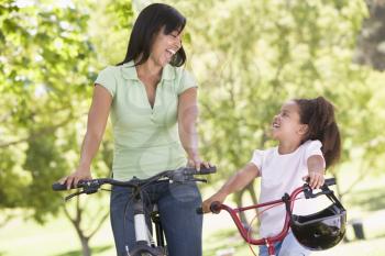 Royalty Free Photo of a Girl and Her Mother on Bikes