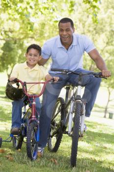 Royalty Free Photo of a Man and Boy With Bikes