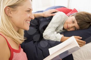 Royalty Free Photo of a Woman Reading a Bedtime Story to Her Son